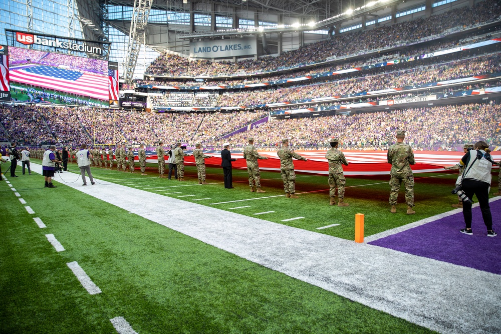 TF McCoy Soldiers Present Flag At NFL Game