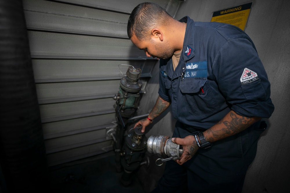 USS Sioux City Sailor Disconnects the Fueling Hose During Refueling Ops