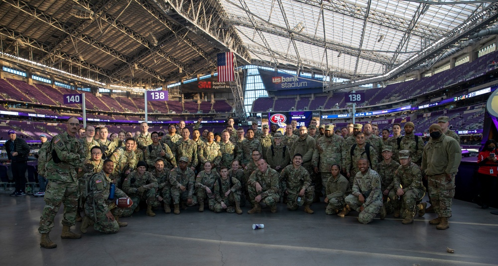 TF McCoy Soldiers Present Flag At NFL Game