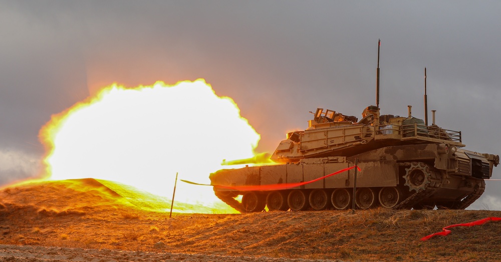 Latvian Land Forces Mechanized Brigade Commander Col. Sandris Gaugers fires an M1 Abrams with 3rd Battalion, 66th Armored Regiment (3-66), 1st Armored Brigade Combat Team, 1st Infantry Division