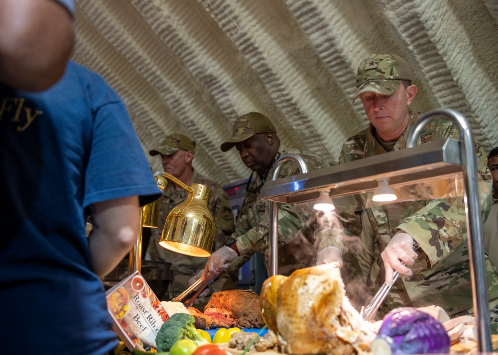 332nd Expeditionary Force Support Squadron, commanders serve Thanksgiving meal to deployed service members