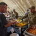 332nd Expeditionary Force Support Squadron, commanders serve Thanksgiving meal to deployed service members