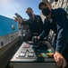 USS Sioux City Sailors Maneuver the Ship Away from the Pier