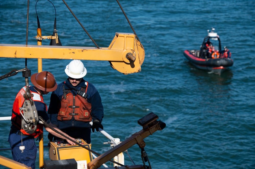 Crew members of the Coast Guard Cutter Aspen conduct small boat hoisting evolutions