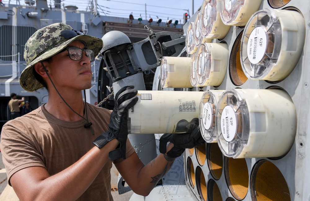 USS Chafee (DDG 90) Conducts Maintenance On A MH-60R Sea Hawk