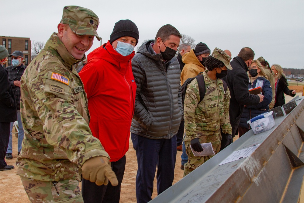 Attendees sign the last steel beam for the Fort Leonard Wood Replacement Hospital project