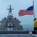 USS Charleston Sailor Observes Evening Colors