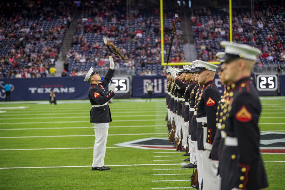 Marines with the Silent Drill Platoon perform during a halftime show at NRG Stadium in Houston, Texas