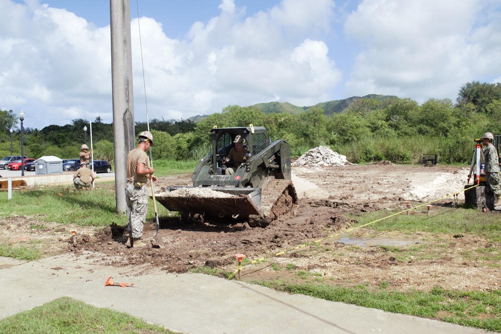 US Navy Seabees with NMCB-5 excavate asphalt onboard Naval Base Guam