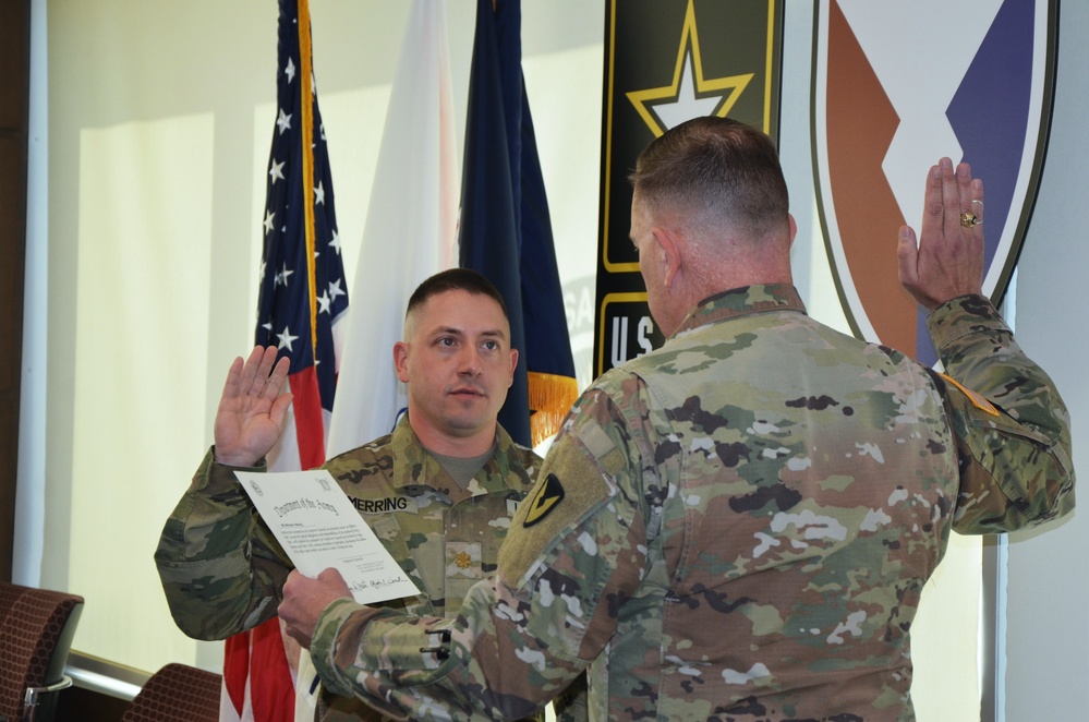 Brig. Gen. Garrick Harmon swears in the new deputy inspector general at the USASAC headquarters building on Redstone Arsenal