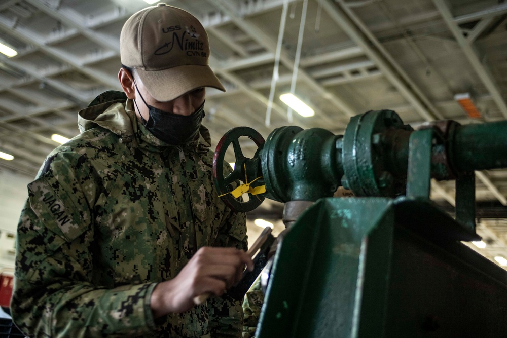 Sailor Maintains Firefighting Equipment