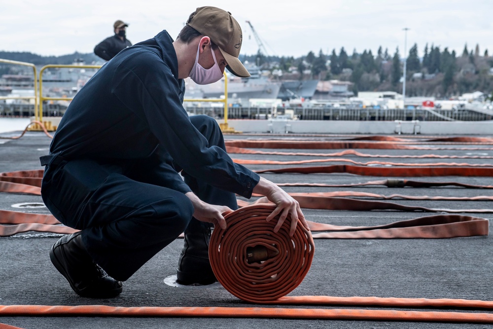 Sailor Rolls Up Firehose