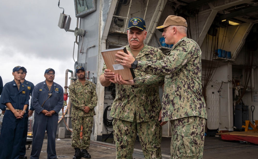 Capt. Joe Ring presents a USS Arizona relic to USS Port Royal