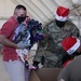 Volunteers pack donated goods into airdrop bundles during the 70th annual Operation Christmas Drop