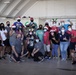 Volunteers pack donated goods into airdrop bundles during the 70th annual Operation Christmas Drop