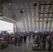 Volunteers pack donated goods into airdrop bundles during the 70th annual Operation Christmas Drop