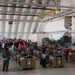 Volunteers pack donated goods into airdrop bundles during the 70th annual Operation Christmas Drop