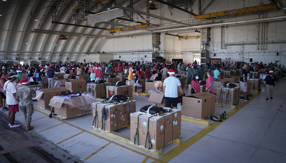Volunteers pack donated goods into airdrop bundles during the 70th annual Operation Christmas Drop