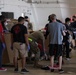 Volunteers pack donated goods into airdrop bundles during the 70th annual Operation Christmas Drop