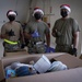 Volunteers pack donated goods into airdrop bundles during the 70th annual Operation Christmas Drop