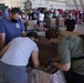 Volunteers pack donated goods into airdrop bundles during the 70th annual Operation Christmas Drop