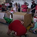 Volunteers pack donated goods into airdrop bundles during the 70th annual Operation Christmas Drop