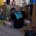 Volunteers pack donated goods into airdrop bundles during the 70th annual Operation Christmas Drop