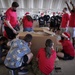 Volunteers pack donated goods into airdrop bundles during the 70th annual Operation Christmas Drop