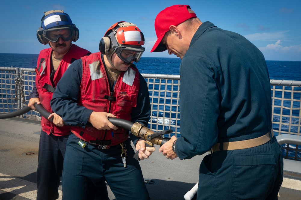 USS Sioux City Sailors Adjust Fire Hose Nozzle During Flight Deck Fire Drill