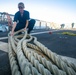 USS Sioux City Sailor Fakes Down a Line During Sea and Anchor Detail