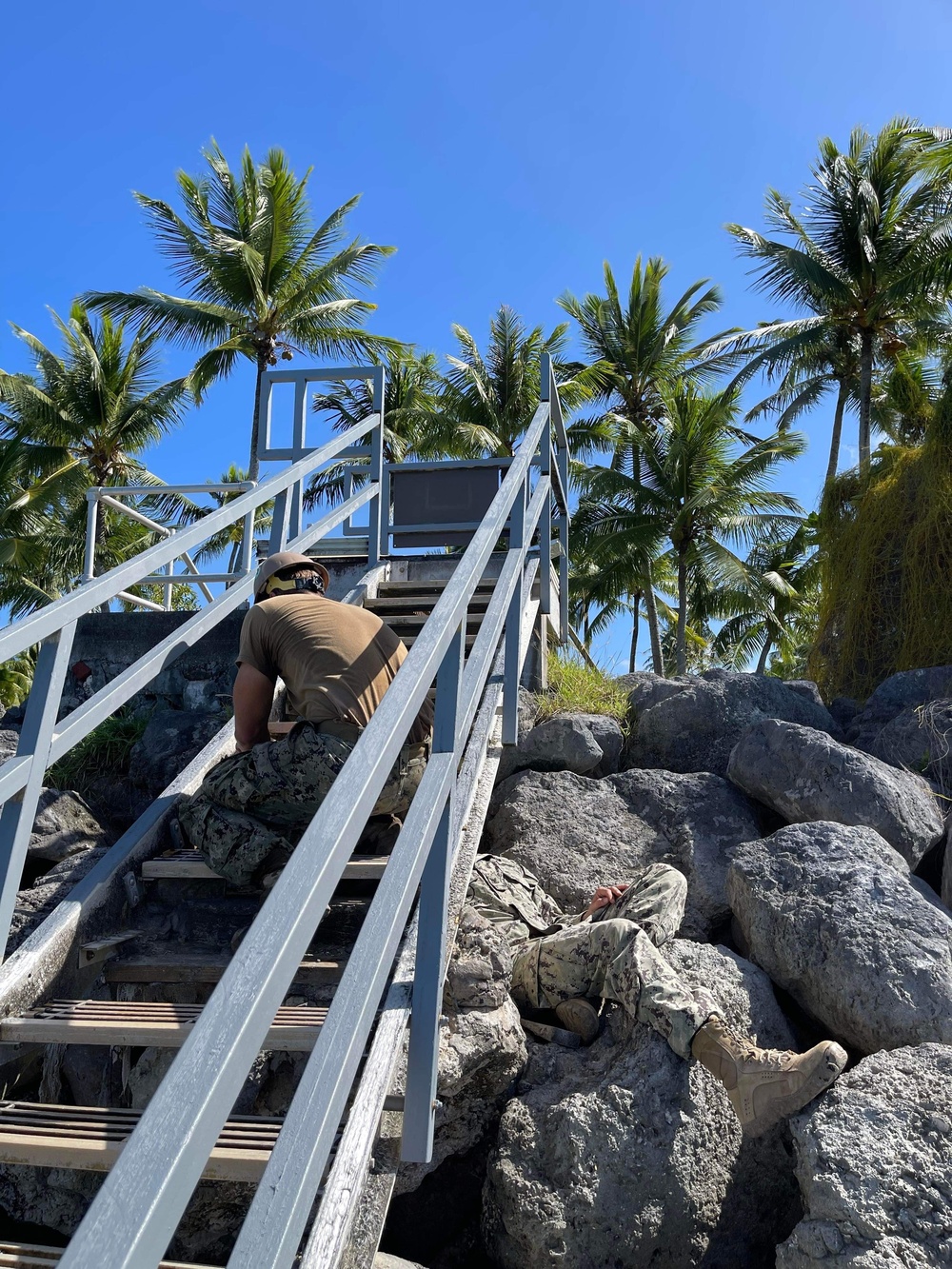 US Navy Seabees with NMCB- 5 repair a staircase for the locals in Marshall Islands