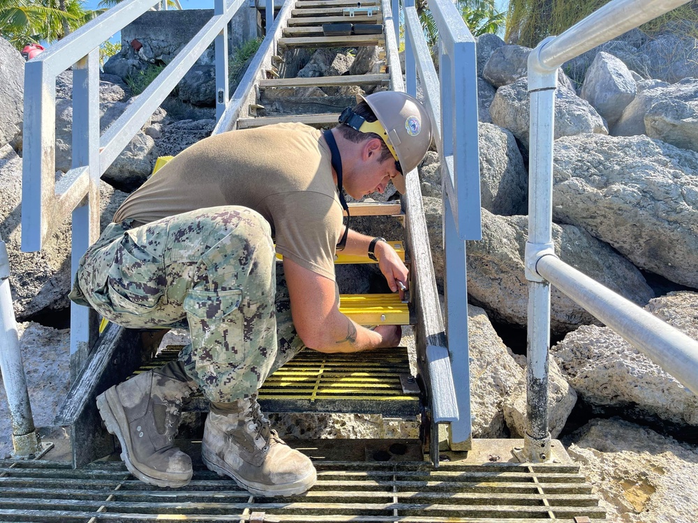 US Navy Seabees with NMCB- 5 repair a staircase for the locals in Marshall Islands