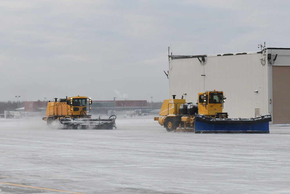 Air National Guard Heavy Equipment Operators remove snow