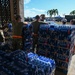 Military volunteers distribute water