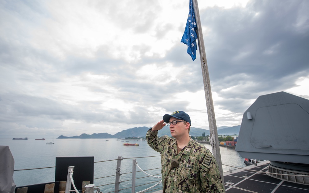 USS Charleston Sailor Observes Morning Colors