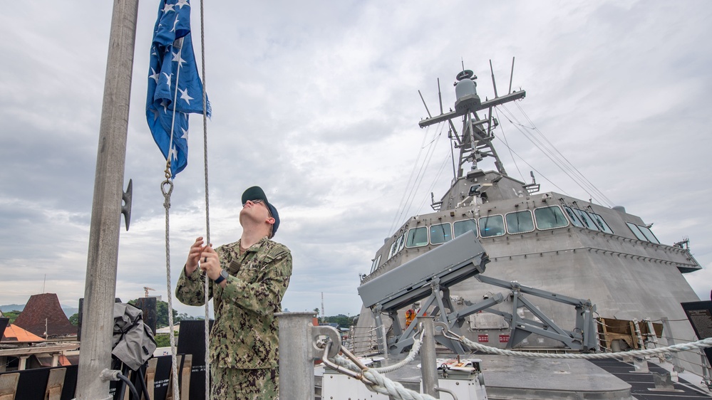 USS Charleston Sailor Observes Morning Colors