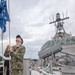 USS Charleston Sailor Observes Morning Colors