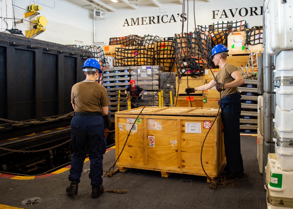 USS Carl Vinson (CVN 70) Sailors Move Cargo in Hangar Bay