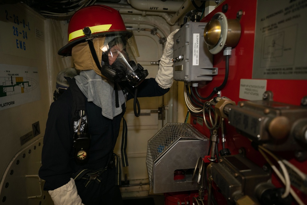 USS Sioux City Sailor Safety Checks Equipment During Mass Conflagration Drill