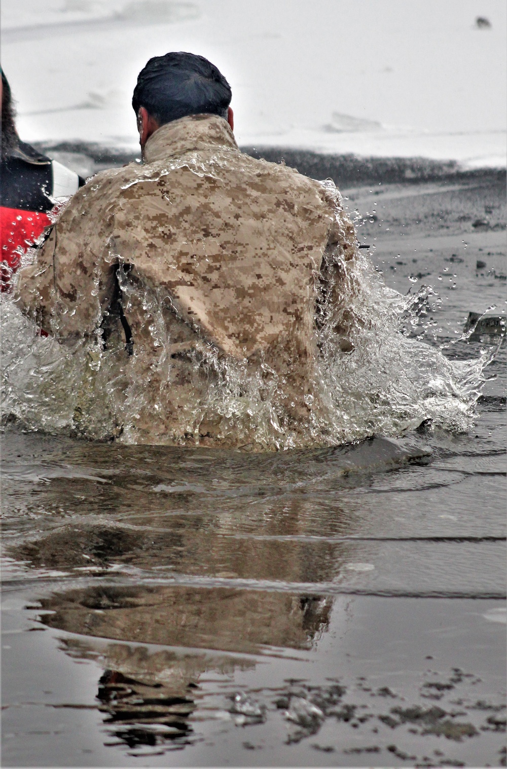 6th Marine Regiment troops jump in for cold-water immersion training at Fort McCoy