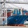 A large COSCO container ship named 'COSCO Shipping Rose' is docked at the Port of Savannah, Georgia, USA. The vessel is loaded with hundreds of multicolored intermodal shipping containers and is serviced by large ship-to-shore gantry cranes numbered 42 and 43. The port appears to be actively engaged in cargo loading or unloading operations.