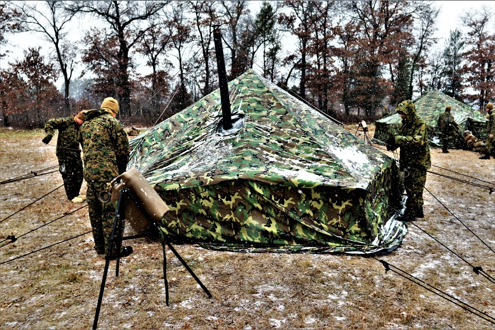 Marines practice tent building during Cold-Weather Operations Course training at Fort McCoy