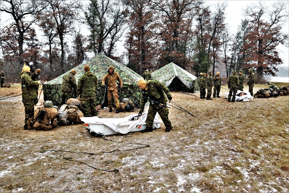 Marines practice tent building during Cold-Weather Operations Course training at Fort McCoy