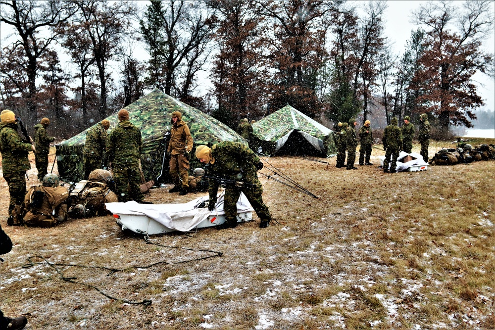 Marines practice tent building during Cold-Weather Operations Course training at Fort McCoy