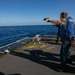 USS Sioux City Sailor Fires Gun During a Live-Fire Exercise