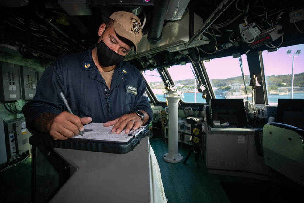USS Sioux City Sailor Writes in the Deck Log During Sea and Anchor Detail