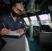USS Sioux City Sailor Writes in the Deck Log During Sea and Anchor Detail