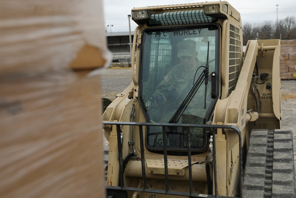 Soldiers load palatized supplies for tornado relief efforts