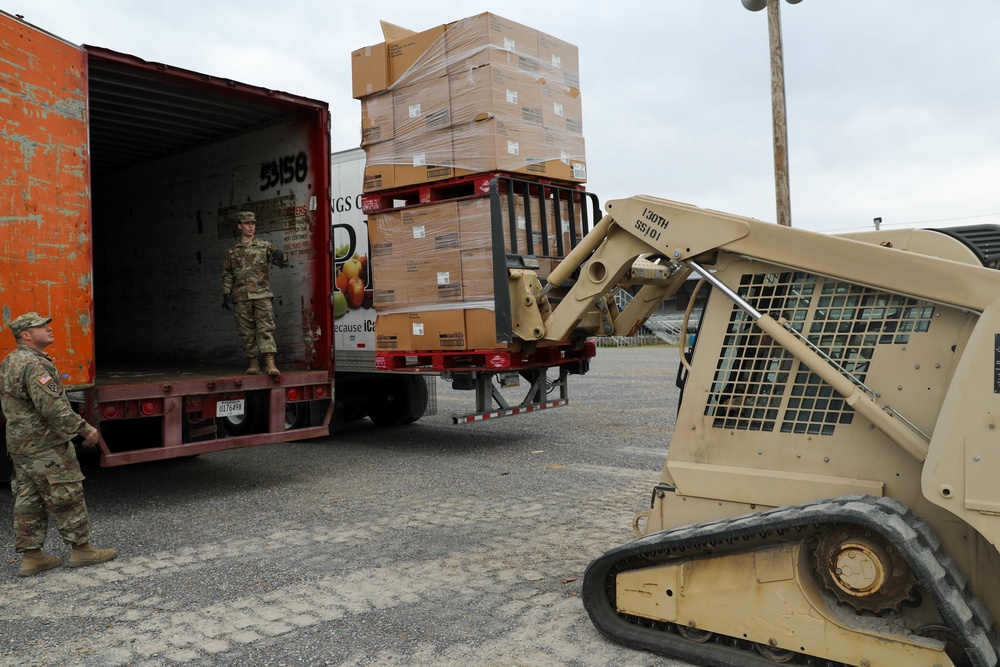 Soldiers load palatized supplies for tornado relief efforts