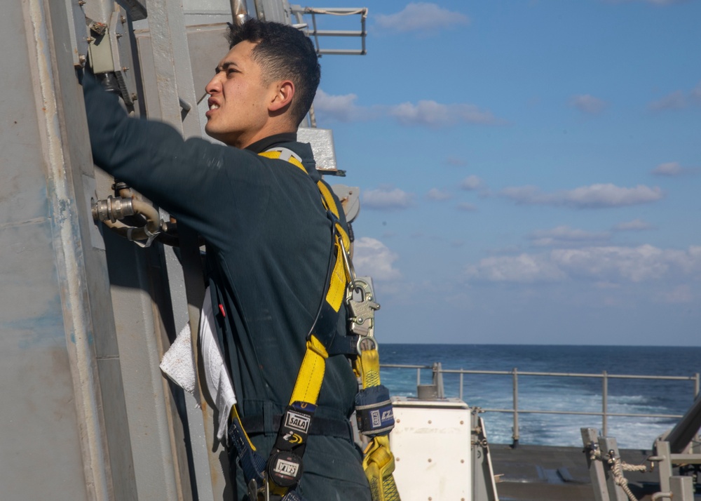 Sailor Performs Maintenance on Sliding Padeye